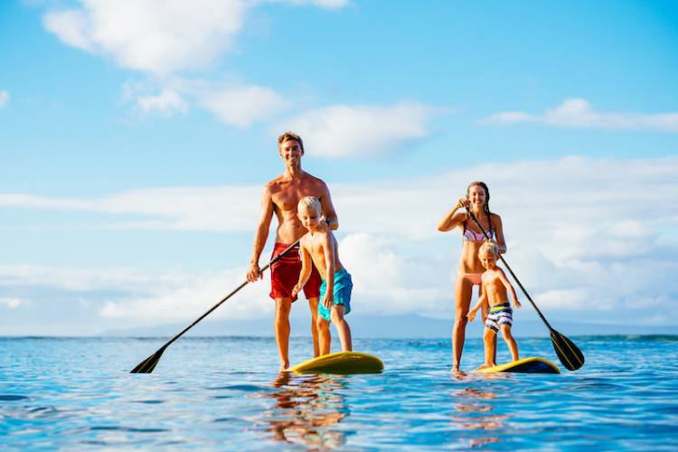 A family paddle-boards near Ocean Isle Beach