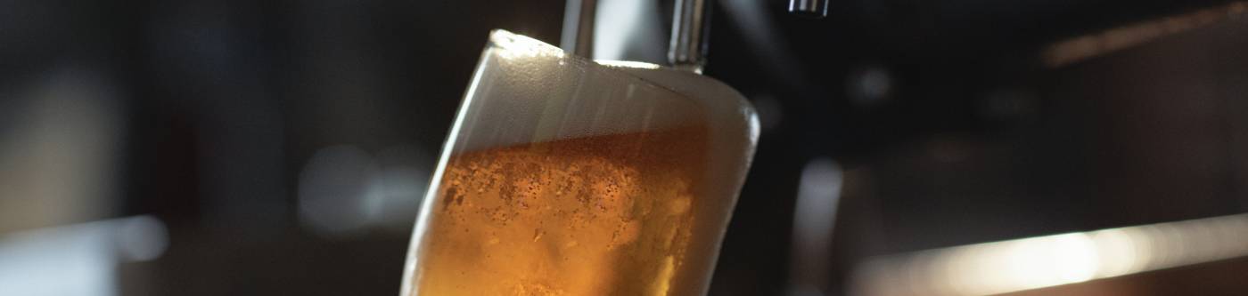 A man pours a beer at a brewery