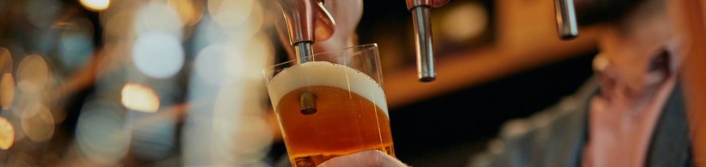 A man pours a beer at a brewery