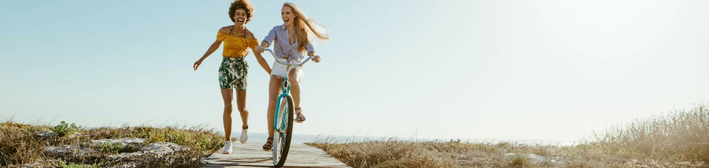 Two girls bike near Ocean Isle Beach